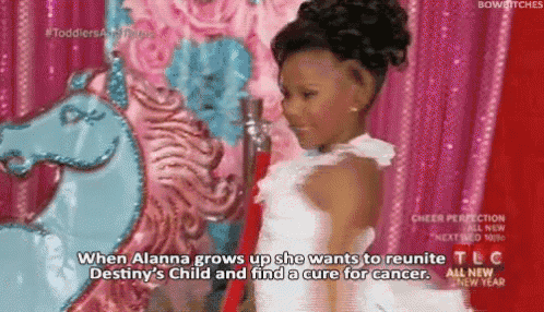 a little girl in a white dress is standing in front of a blue unicorn