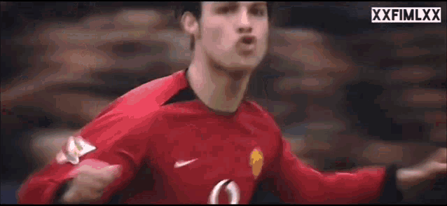 a blurry picture of a soccer player wearing a red jersey