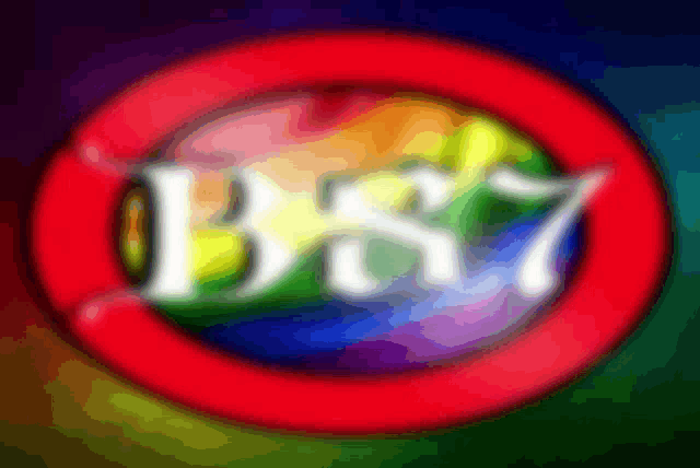 a blurry picture of a rainbow colored circle with the letters bs7 inside