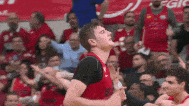 a basketball player wearing a red jersey that says ecl on it
