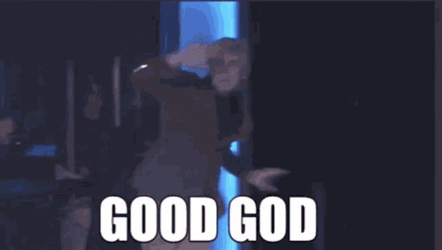a man in a suit and turtleneck is making a funny face and says good god