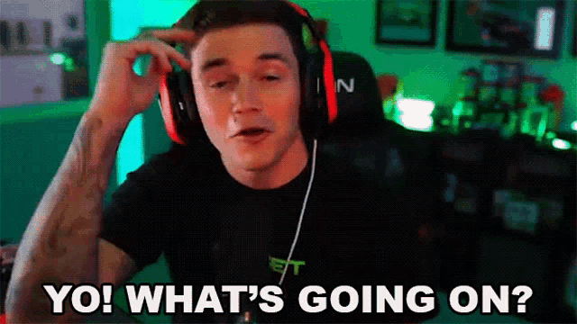 a man wearing headphones and a black shirt says yo what 's going on