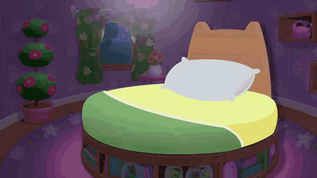 a round bed with a pillow on it in a room