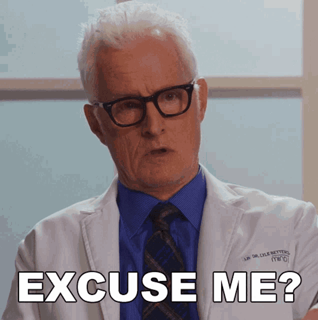 a man in a lab coat says " excuse me " while wearing glasses