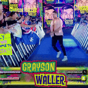 grayson waller is walking down a blue carpet in front of a crowd of people