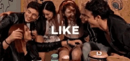 a group of young people are taking a selfie together in a room .