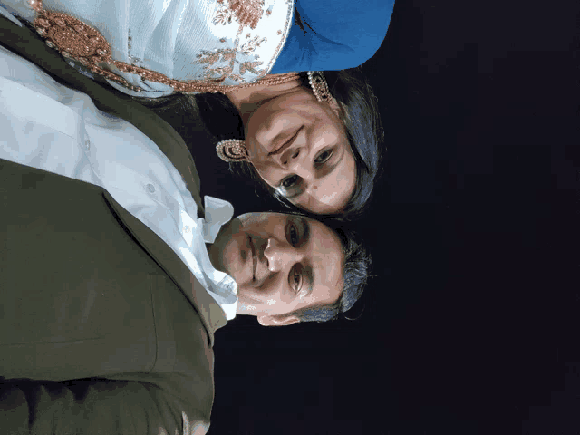 a man and a woman are posing for a picture with their heads together