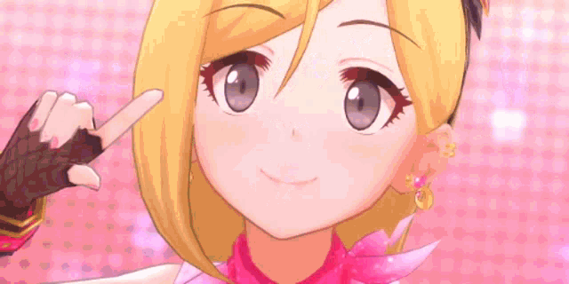 a close up of a cartoon girl with blonde hair pointing at something .