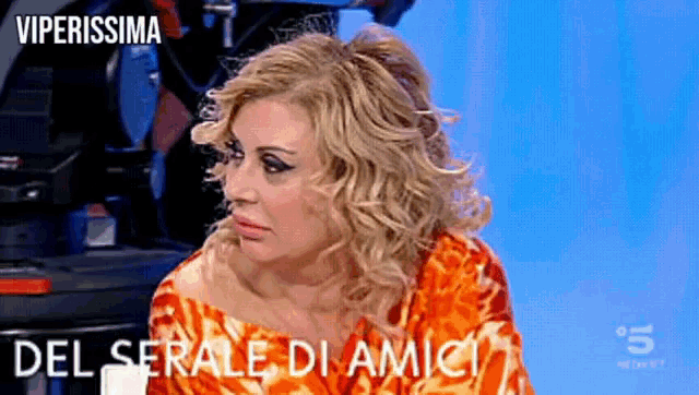 a woman on a tv show with the words viperissima del serale di amici below her