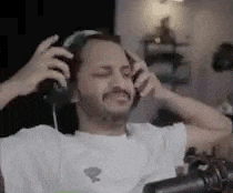 a man is sitting in front of a microphone wearing headphones .