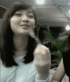 a woman in a white shirt is holding a knife in her hand