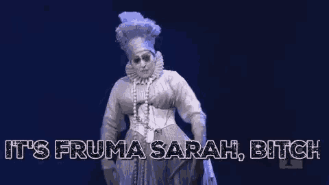 a woman in a costume is dancing on a stage and saying `` it 's fruma sarah bitch '' .