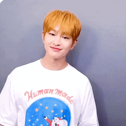 a man wearing a white shirt that says human made on it