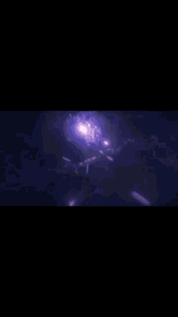 a purple light is shining through a dark room