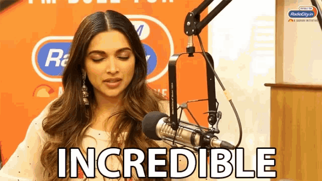 a woman is sitting in front of a microphone and the word incredible is visible