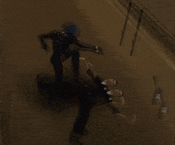 a man is laying on the ground with a gun flying in the air