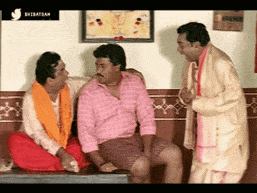 three men are having a conversation in front of a sign that says ' shibibatsam '