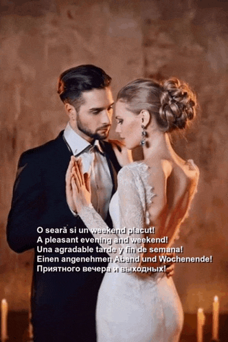 a man in a suit and a woman in a white dress are dancing together