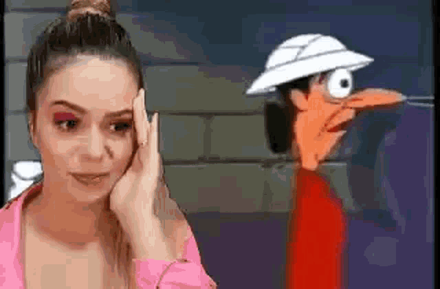 a woman is standing in front of a cartoon character with a hat on .
