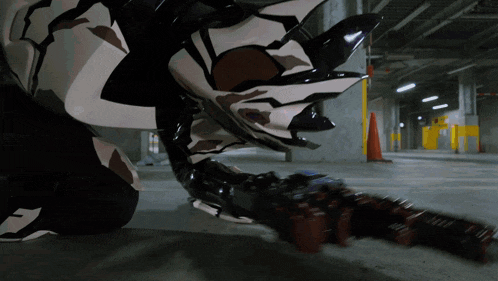 a person is kneeling down in a parking garage holding a gun