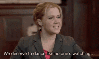 a woman in a suit is saying we deserve to dance like no one 's watching ...