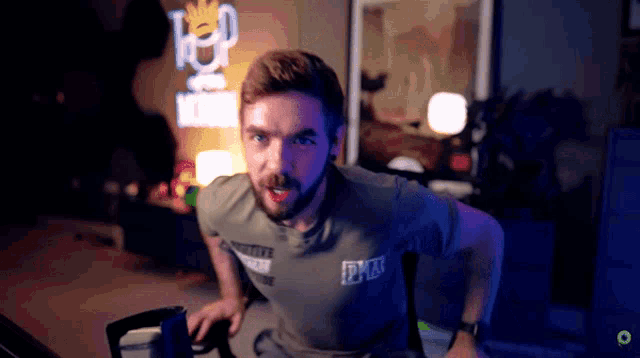 a man with a beard wearing a shirt that says dkn