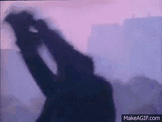 a silhouette of a person looking through binoculars with makeagif.com in the lower right corner