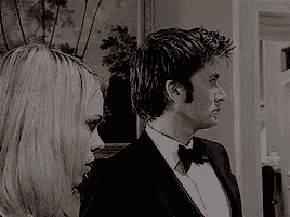 a man and a woman are standing next to each other in a room .