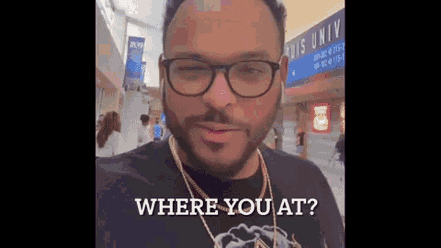 a man wearing glasses and a black shirt is asking where you at