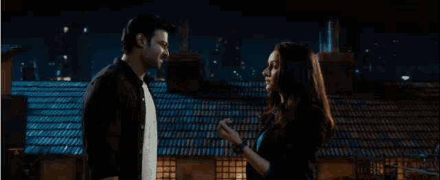 a man and a woman are looking at each other .