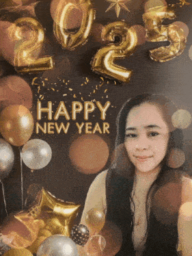 a woman stands in front of balloons and a happy new year sign