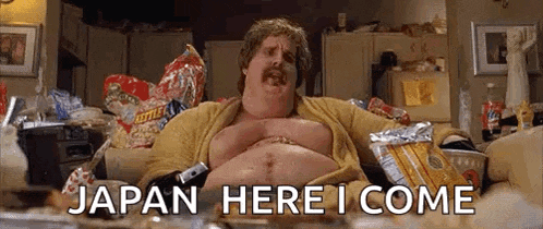 a fat man with a mustache is sitting on a couch with a pile of chips .