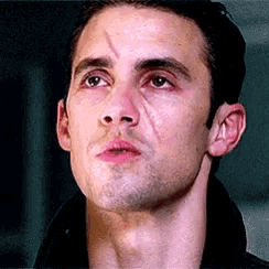 a close up of a man with a scar on his face .