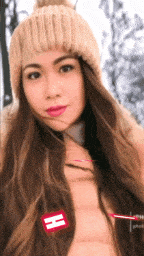 a woman with long hair wearing a hat and a red h