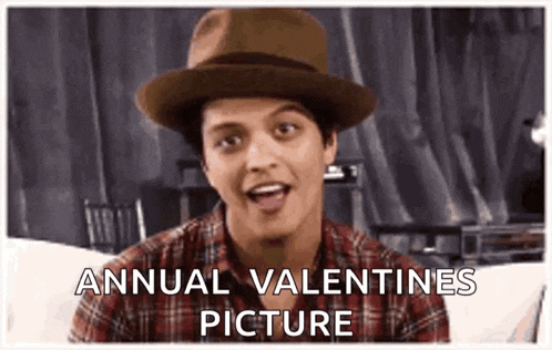 a man wearing a hat and a plaid shirt says annual valentines picture .