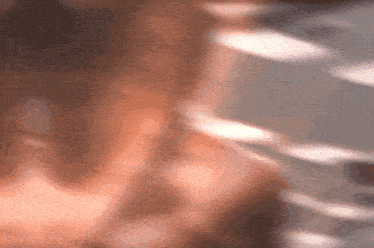 a blurred image of a person 's face with a few white lines