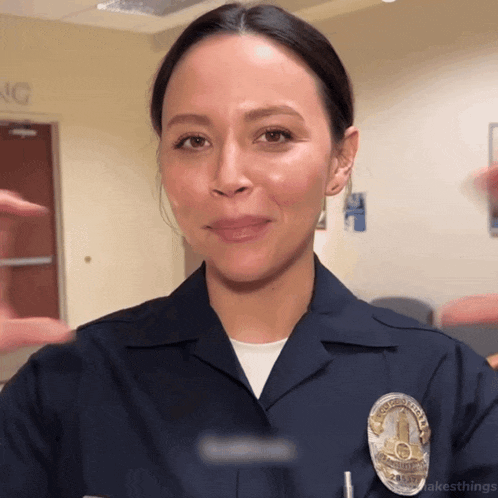 a woman in a police uniform with a badge that says los angeles police