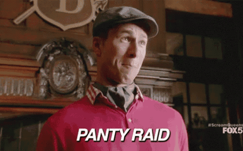 a man in a red shirt says panty raid in white letters