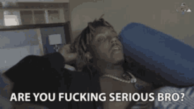 a man is laying on a bed with the words " are you fucking serious bro " on the bottom