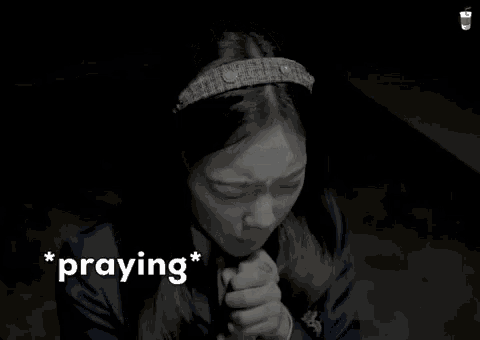 a woman with her hands folded praying with the word praying below her