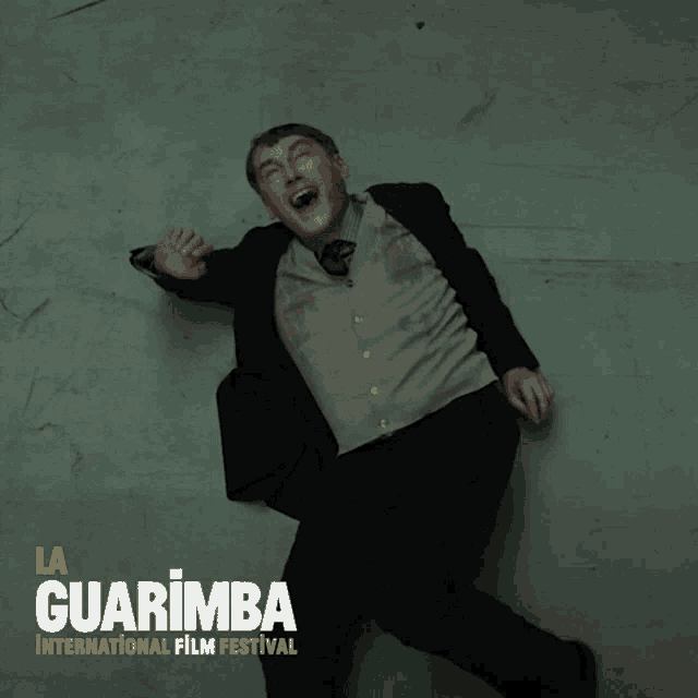 a poster for la guarimba international film festival with a man on the floor