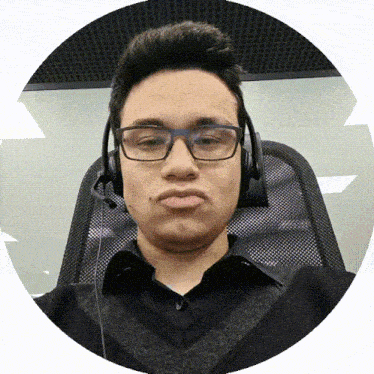 a young man wearing glasses and headphones makes a funny face