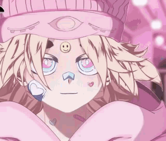 a girl with a smiley face on her forehead is wearing a pink hat and hoodie .