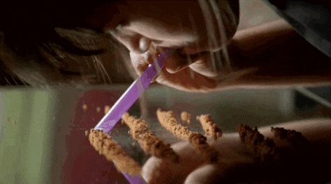a person is drinking from a purple straw