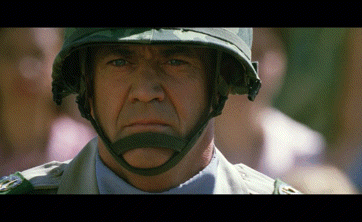 a close up of a man wearing a helmet looking at the camera