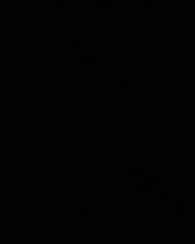a man wearing glasses is smiling in the dark