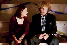 a man and a woman sitting next to each other on a bench