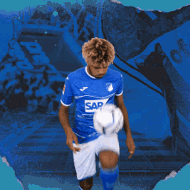 a man in a blue shirt with the word sap on it is throwing a soccer ball
