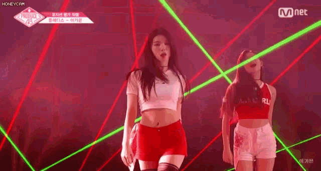 a couple of women are dancing on a stage .