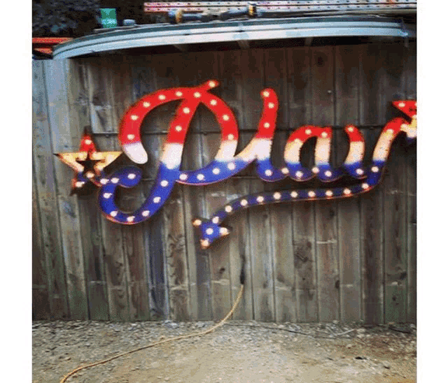 a red white and blue sign that says " play "